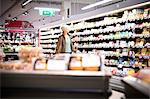 Mature woman looking at grocery shelves in supermarket