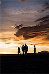 Silhouette of people in desert at sunset, San Pedro de Atacama, Chile