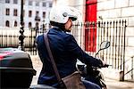 Businessman on motorbike, London, UK