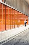 Businessman strolling outside office building