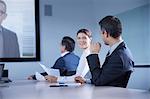 Businesswoman looking over her shoulder during office conference call