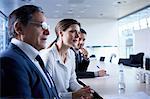 Businesswoman and men listening at office meeting