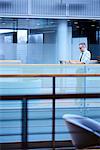 Mature businessman looking at smartphone call on office balcony