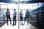 Businessman and woman talking on office balcony