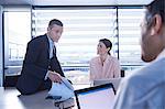 Businessmen and woman meeting at office desk