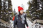 Hiker on walkway by snow covered trees, Banff, Canada