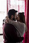 Young couple, at home, kissing