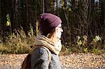 Young woman hiking along country road, side view, Sverdlovsk Oblast, Russia