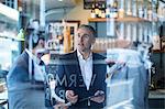 Businessmen and woman having discussion in restaurant