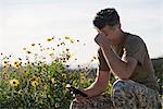 Soldier wearing combat clothing looking at smartphone, Runyon Canyon, Los Angeles, California, USA