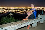 Long exposure of jogger on bench looking away at view, Runyon Canyon, Los Angeles, California, USA