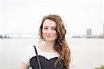 Portrait of woman in front of New orleans bridge, Mississippi river, French Quarter, New Orleans, Louisiana, USA