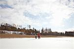 Father and two sons, walking through snow covered landscape