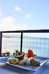 Fresh tropical breakfast fruit plate, with mango, papaya, banana and passion fruit, overlooking the water, Saint Lucia, Caribbean