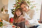 Mother and daughter holding Christmas star