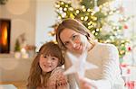 Portrait smiling mother and daughter holding Christmas star