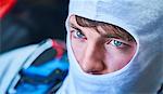 Close up serious race car driver wearing protective mask