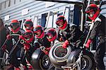 Pit crew ready with tires in formula one pit lane