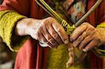 Close up of woman weaving a basket in a weaver's workshop.