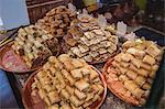 Close-up of turkish sweets in plate on display at counter in shop