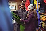 Couple selecting apparel together in a clothes shop