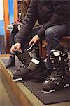 Close-up of man wearing a ski boot in a shop