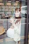 Pregnant businesswoman having fruit juice in office cafeteria