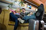 Smiling couple interacting with each other in waiting area at airport terminal