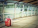 stack of traveling luggage in airport terminal and passenger plane flying over building in city