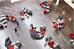 Students in the atrium of modern university, elevated view