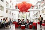 Groups of students meet in the lobby of their university