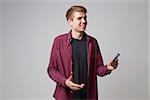 Studio Portrait Of Male Journalist With Digital Recorder