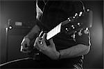 Close Up Of Man Playing Electric Guitar Shot In Monochrome