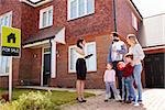 Realtor Outside House For Sale With Young Family