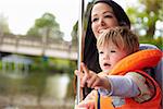 Mother And Son Enjoying Day Out In Boat On River Together