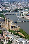 PALACE OF WESTMINSTER, London. Aerial view of the Houses of Parliament, River Thames and London Eye wheel.