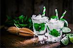 Mojitos with ice cubes, mint and limes