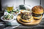 Healthy homemade burgers with vegetable salad and beer