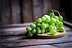 Green grapes on a rustic wooden surface