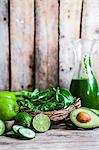 Ingredients for green smoothies on a rustic wooden surface