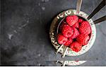 Fresh raspberries in silver cups