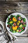 A mixed salad with spinach, rocket and heirloom tomatoes