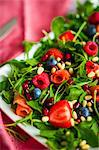Healthy salad with rocket, spinach, smoked salmon and berries
