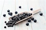 Dried blueberries on a wooden scoop