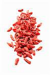 Dried goji berries on a white surface