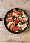 Fried lobster tails with garlic in a pan