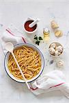 Ingredients for a pasta dish: penne, mushrooms, sieved tomatoes, olive oil and Ginger