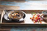 Steaming lentil soup on a wooden tray