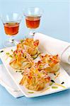 Sweet filo pastry sacks with pistachios and icing sugar served with dessert wine