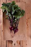 Beetroot with leaves on a wooden chopping board